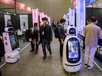 Visitors explore various company booths showcasing robotics and automation technologies at 'RoboWorld 2024,' held at KINTEX in Goyang, South...