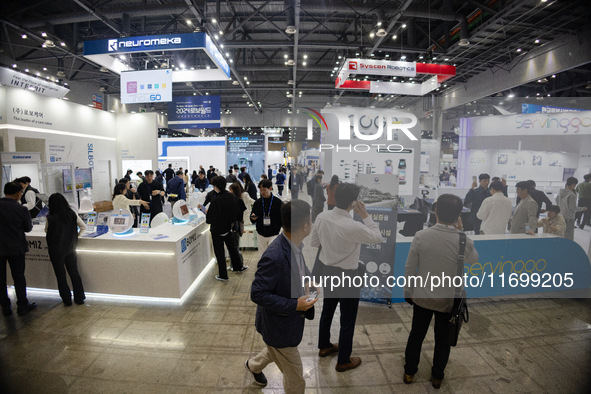 Visitors explore various company booths showcasing robotics and automation technologies at 'RoboWorld 2024,' held at KINTEX in Goyang, South...