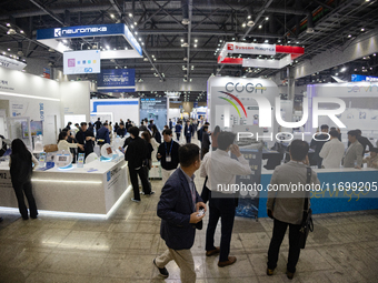 Visitors explore various company booths showcasing robotics and automation technologies at 'RoboWorld 2024,' held at KINTEX in Goyang, South...