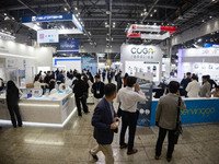 Visitors explore various company booths showcasing robotics and automation technologies at 'RoboWorld 2024,' held at KINTEX in Goyang, South...