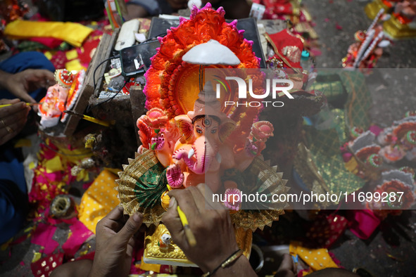 An artist gives finishing touches to an idol of the Hindu Goddess of wealth, Lakshmi, ahead of the Diwali festival, the festival of lights,...