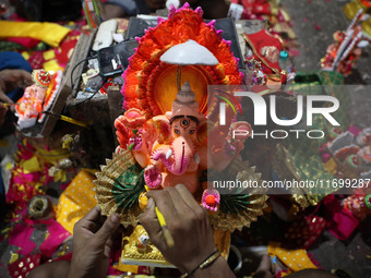 An artist gives finishing touches to an idol of the Hindu Goddess of wealth, Lakshmi, ahead of the Diwali festival, the festival of lights,...