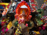 An artist gives finishing touches to an idol of the Hindu Goddess of wealth, Lakshmi, ahead of the Diwali festival, the festival of lights,...