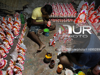 Artists give finishing touches to idols of the Hindu God Ganesh, the God of prosperity, and the Hindu goddess of wealth, Lakshmi, ahead of t...