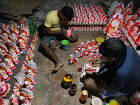 Artists give finishing touches to idols of the Hindu God Ganesh, the God of prosperity, and the Hindu goddess of wealth, Lakshmi, ahead of t...