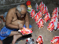 An artist gives finishing touches to an idol of the Hindu Goddess of wealth, Lakshmi, ahead of the Diwali festival, the festival of lights,...