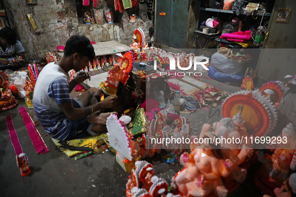 Artists give finishing touches to idols of the Hindu God Ganesh, the God of prosperity, and the Hindu goddess of wealth, Lakshmi, ahead of t...