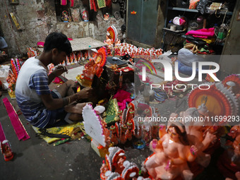 Artists give finishing touches to idols of the Hindu God Ganesh, the God of prosperity, and the Hindu goddess of wealth, Lakshmi, ahead of t...