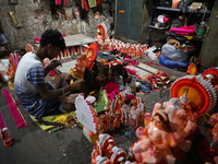 Artists give finishing touches to idols of the Hindu God Ganesh, the God of prosperity, and the Hindu goddess of wealth, Lakshmi, ahead of t...