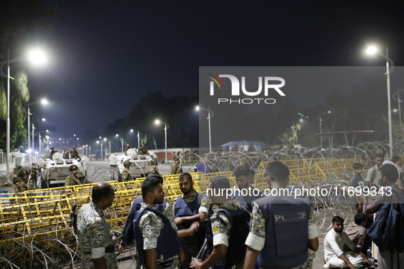 Law enforcers stand guard in front of the Bangabhaban, the residence and workplace of President Mohammed Shahabuddin, after protesters deman...