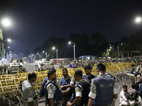 Law enforcers stand guard in front of the Bangabhaban, the residence and workplace of President Mohammed Shahabuddin, after protesters deman...