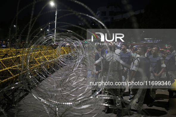 Law enforcers stand guard in front of the Bangabhaban, the residence and workplace of President Mohammed Shahabuddin, after protesters deman...