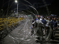 Law enforcers stand guard in front of the Bangabhaban, the residence and workplace of President Mohammed Shahabuddin, after protesters deman...