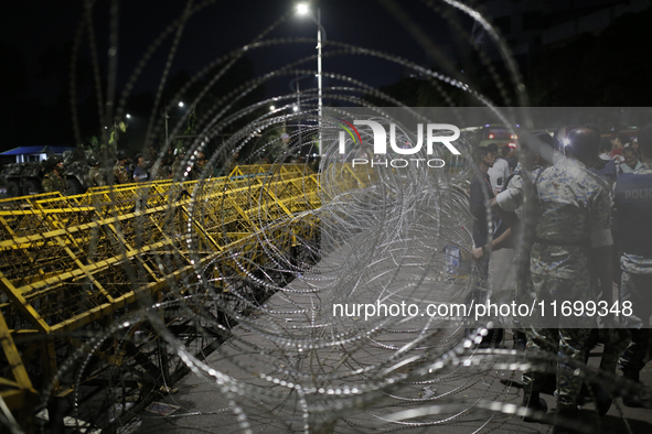 Law enforcers stand guard in front of the Bangabhaban, the residence and workplace of President Mohammed Shahabuddin, after protesters deman...