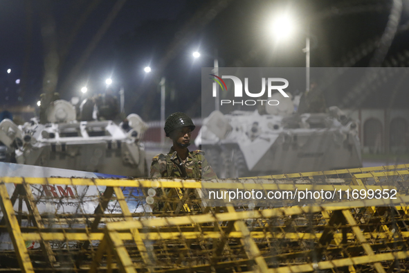 Army personnel stand guard in front of the Bangabhaban, the residence and workplace of President Mohammed Shahabuddin, after protesters dema...