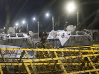 Army personnel stand guard in front of the Bangabhaban, the residence and workplace of President Mohammed Shahabuddin, after protesters dema...