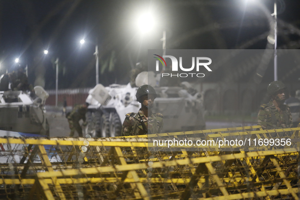 Army personnel stand guard in front of the Bangabhaban, the residence and workplace of President Mohammed Shahabuddin, after protesters dema...