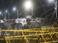 Army personnel stand guard in front of the Bangabhaban, the residence and workplace of President Mohammed Shahabuddin, after protesters dema...