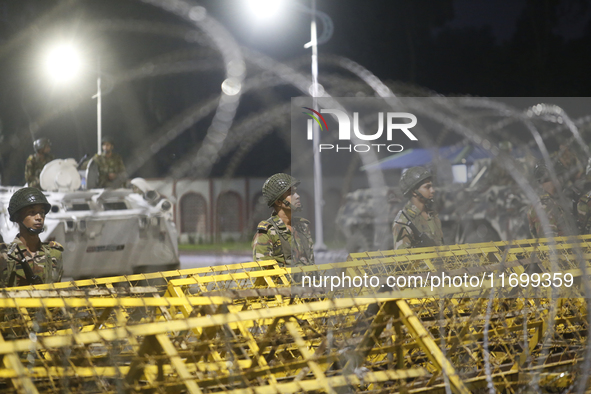 Army personnel stand guard in front of the Bangabhaban, the residence and workplace of President Mohammed Shahabuddin, after protesters dema...