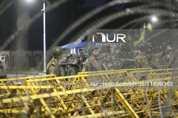 Army personnel stand guard in front of the Bangabhaban, the residence and workplace of President Mohammed Shahabuddin, after protesters dema...