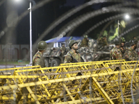 Army personnel stand guard in front of the Bangabhaban, the residence and workplace of President Mohammed Shahabuddin, after protesters dema...