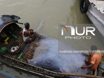 Fishermen catch fish in the Hooghly River near Kolkata, India, on October 23, 2024. (