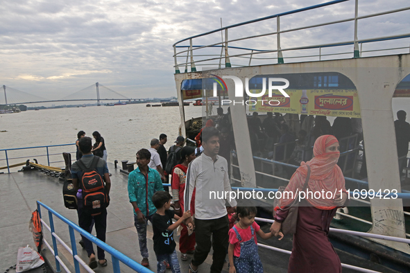 Commuters arrive by boat due to Cyclone Dana in Kolkata, India, on October 23, 2024. 