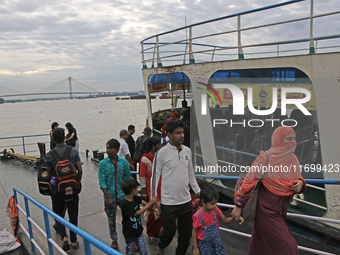 Commuters arrive by boat due to Cyclone Dana in Kolkata, India, on October 23, 2024. (