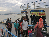 Commuters arrive by boat due to Cyclone Dana in Kolkata, India, on October 23, 2024. (