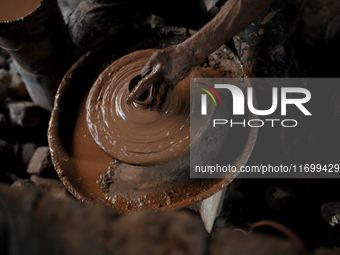 An Indian potter prepares a diya (earthen lamp) at Kumbharwada potter's colony of Dharavi slum in preparation for Diwali (Hindu festival of...