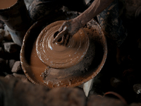 An Indian potter prepares a diya (earthen lamp) at Kumbharwada potter's colony of Dharavi slum in preparation for Diwali (Hindu festival of...