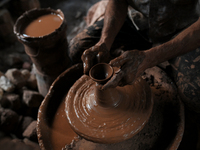 An Indian potter prepares a diya (earthen lamp) at Kumbharwada potter's colony of Dharavi slum in preparation for Diwali (Hindu festival of...