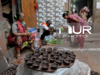 Earthen lamps lay out in the sun to dry at Kumbharwada potter's colony of Dharavi slum in preparation for Diwali (Hindu festival of lights),...