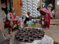 Earthen lamps lay out in the sun to dry at Kumbharwada potter's colony of Dharavi slum in preparation for Diwali (Hindu festival of lights),...