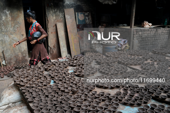 Earthen lamps lay out in the sun to dry at Kumbharwada potter's colony of Dharavi slum in preparation for Diwali (Hindu festival of lights),...