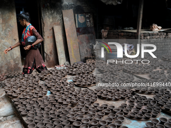 Earthen lamps lay out in the sun to dry at Kumbharwada potter's colony of Dharavi slum in preparation for Diwali (Hindu festival of lights),...