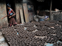 Earthen lamps lay out in the sun to dry at Kumbharwada potter's colony of Dharavi slum in preparation for Diwali (Hindu festival of lights),...