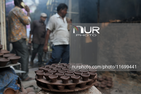 Earthen lamps lay out in the sun to dry at Kumbharwada potter's colony of Dharavi slum in preparation for Diwali (Hindu festival of lights),...