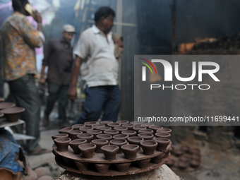 Earthen lamps lay out in the sun to dry at Kumbharwada potter's colony of Dharavi slum in preparation for Diwali (Hindu festival of lights),...