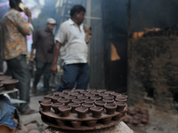 Earthen lamps lay out in the sun to dry at Kumbharwada potter's colony of Dharavi slum in preparation for Diwali (Hindu festival of lights),...