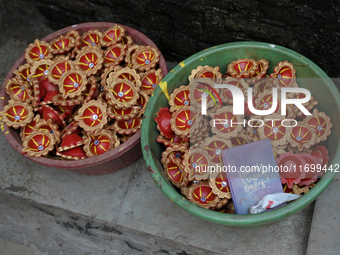 Coloured diyas (earthen lamps) are kept in a storage container at Kumbharwada potter's colony of Dharavi slum in preparation for Diwali (Hin...