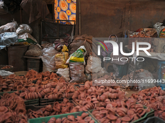 An old woman sells diyas (earthen lamps) to customers at Kumbharwada potter's colony of Dharavi slum in preparation for Diwali (Hindu festiv...