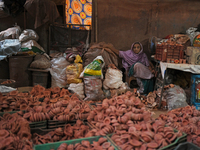 An old woman sells diyas (earthen lamps) to customers at Kumbharwada potter's colony of Dharavi slum in preparation for Diwali (Hindu festiv...