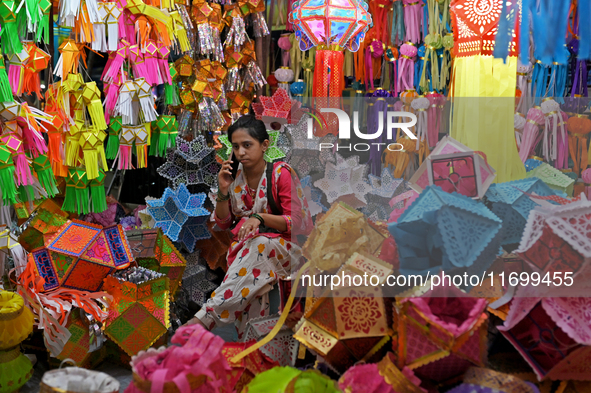 A lantern shopkeeper talks on a phone at a market ahead of the Hindu festival of Diwali in Mumbai, India, on October 23, 2024. 