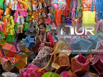 A lantern shopkeeper talks on a phone at a market ahead of the Hindu festival of Diwali in Mumbai, India, on October 23, 2024. (