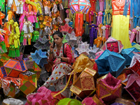 A lantern shopkeeper talks on a phone at a market ahead of the Hindu festival of Diwali in Mumbai, India, on October 23, 2024. (