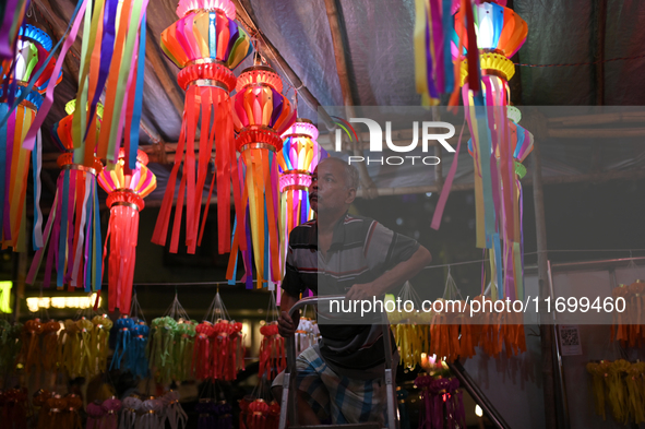 A man arranges a lantern at a market ahead of the Hindu festival of Diwali in Mumbai, India, on October 23, 2024. 