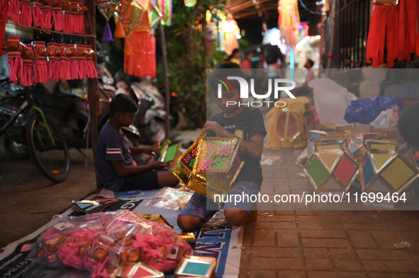 A child makes lanterns at a market ahead of the Hindu festival of Diwali in Mumbai, India, on October 23, 2024. 