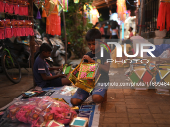 A child makes lanterns at a market ahead of the Hindu festival of Diwali in Mumbai, India, on October 23, 2024. (