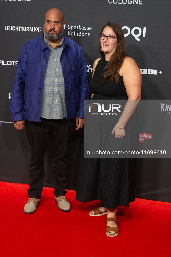 Michael Premo, a filmmaker who receives the Der Phoenix Preis with his companion, is seen on the red carpet of Film Palast in Cologne, Germa...